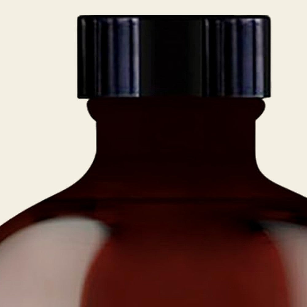 Amber glass bottle of pure tea tree oil